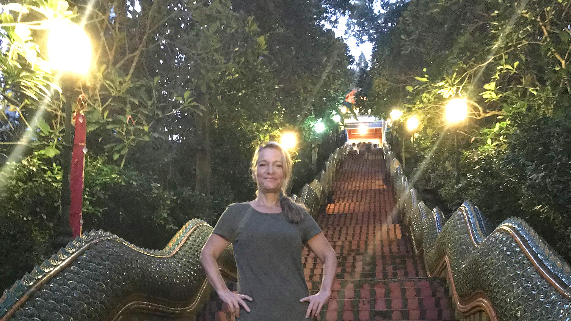Woman standing by very long stairs up at Temple in Chiang Mai